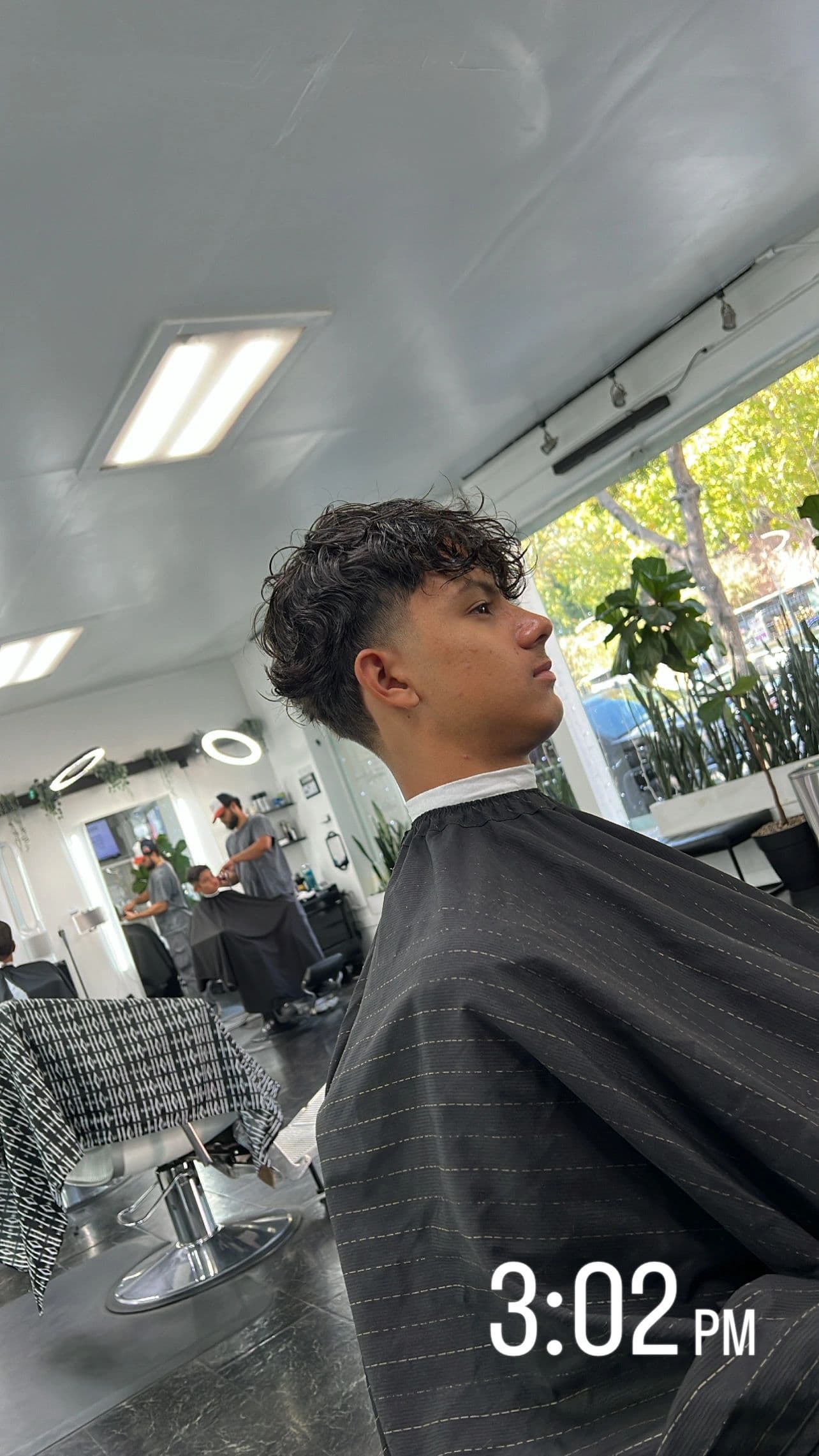 Textured curly fringe with a clean taper
