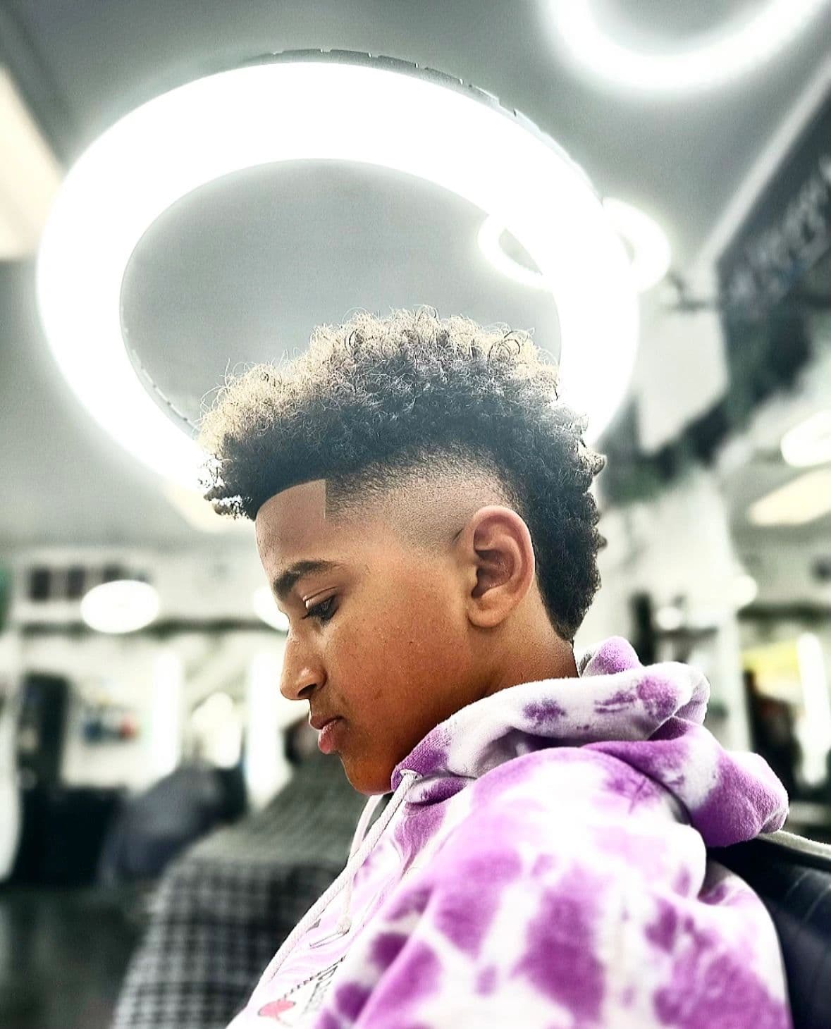 Curly top with a high skin fade